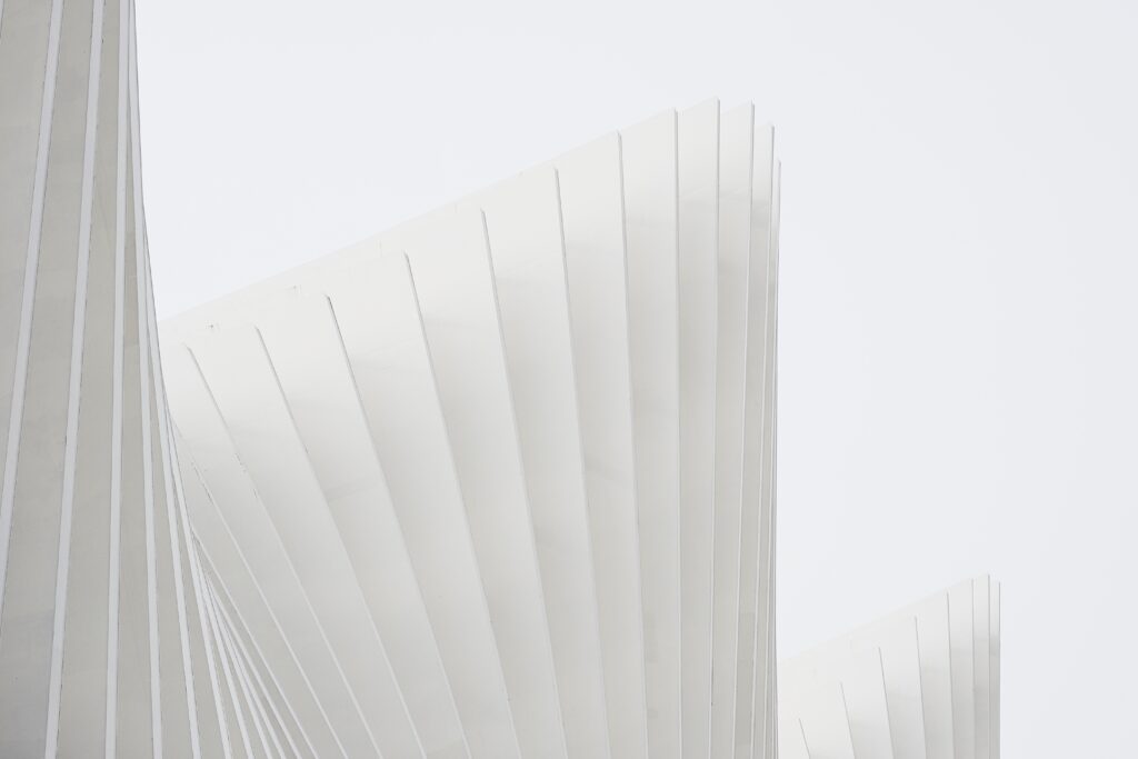 horizontal-shot-abstract-buildings-with-white-metallic-ribs-and-glass-windows-2