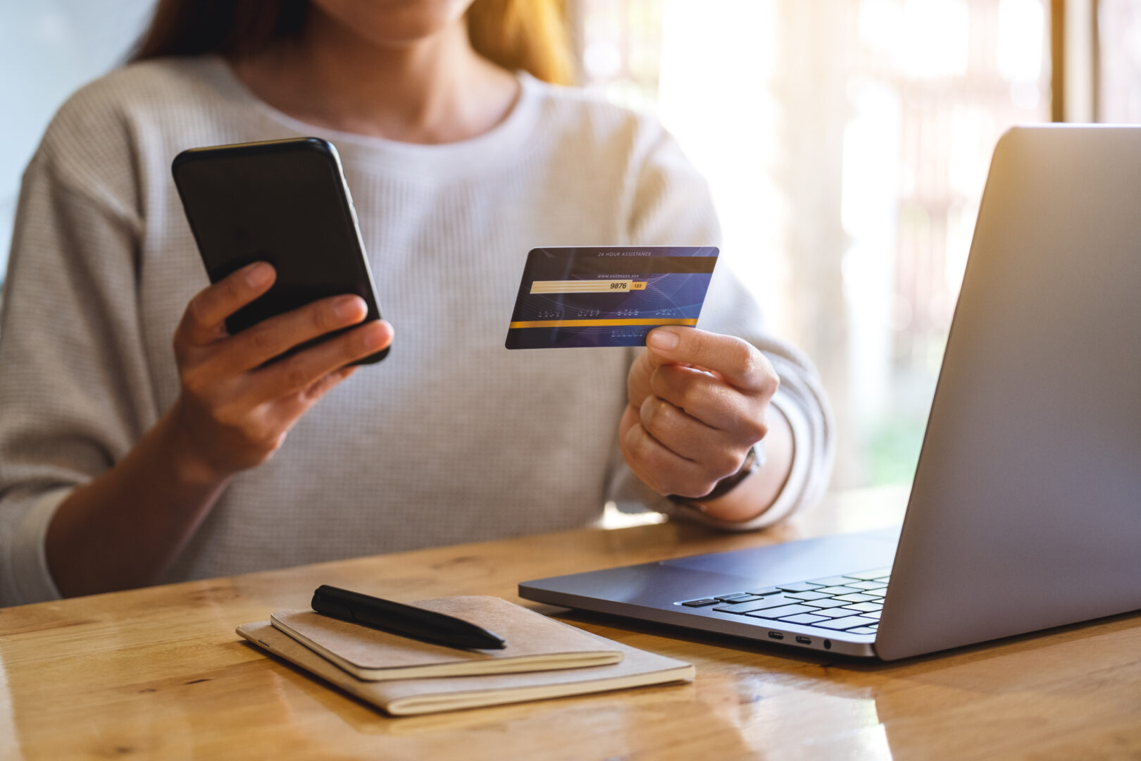 closeup-image-of-a-woman-holding-credit-card-while-using-smart-p