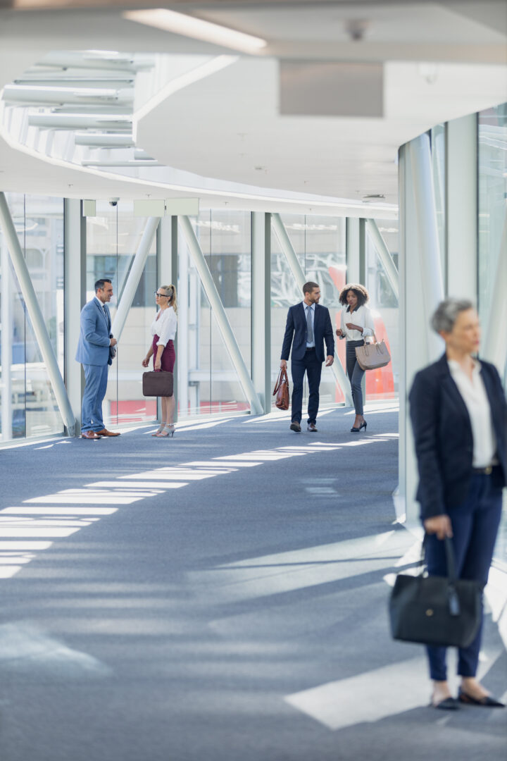 front-view-of-diverse-business-people-walking-in-corridor-in-modern-office