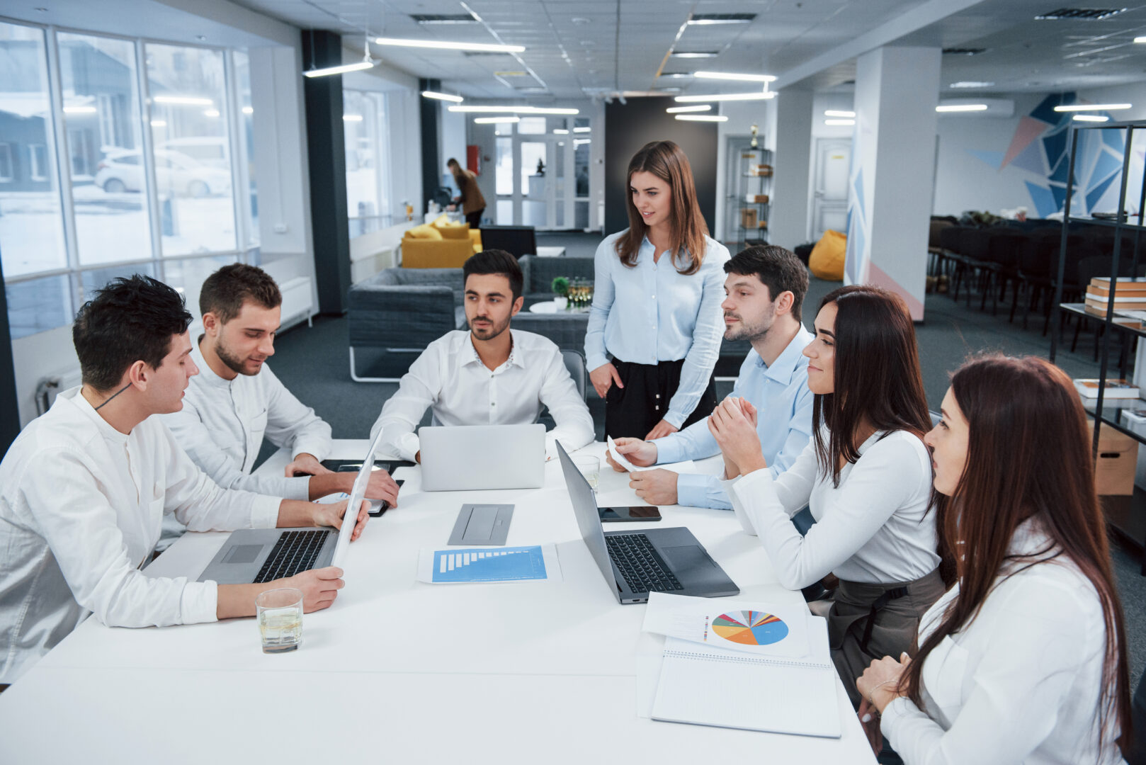 guy-on-the-left-side-talking-and-colleagues-is-listening-to-him-group-of-young-freelancers-in-the-office-have-conversation-and-smiling