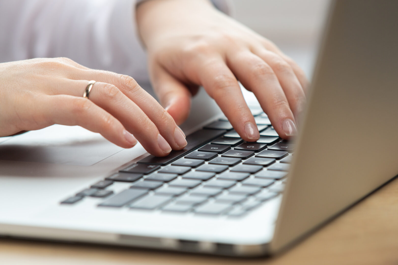 woman-hand-working-on-a-notebook-using-touchpad