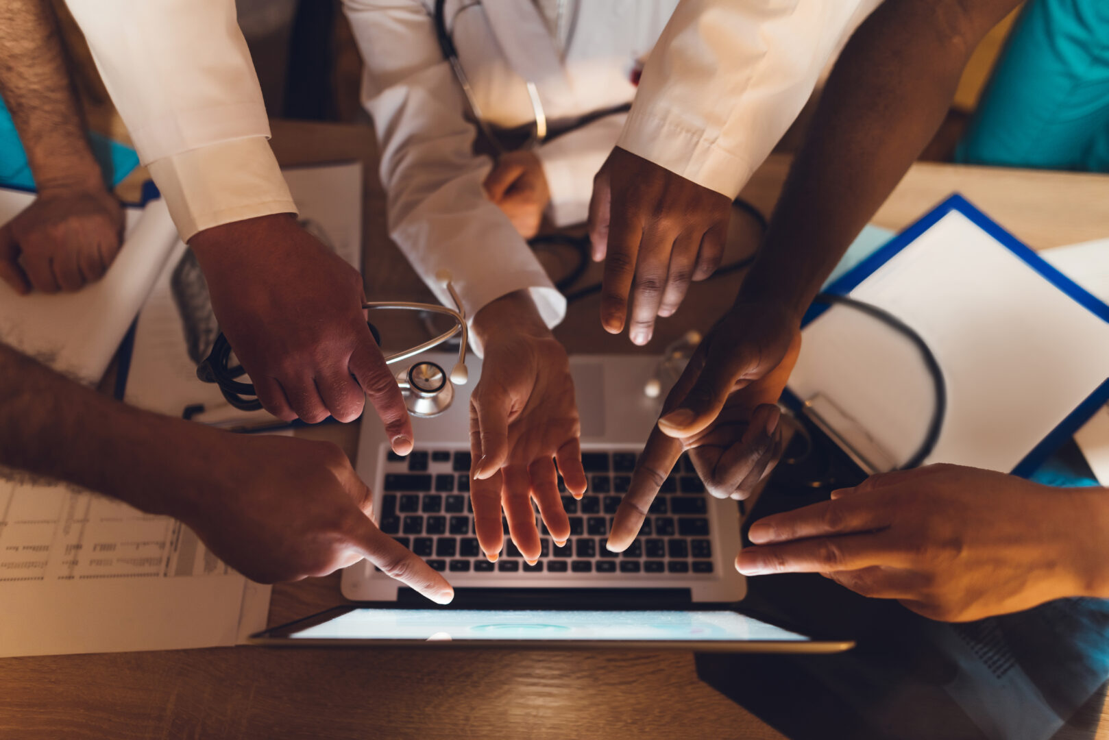 hands-of-doctors-of-different-races-show-on-the-laptop